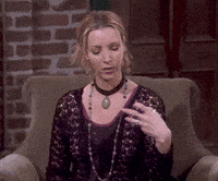 a woman is sitting in a chair wearing a choker and a necklace