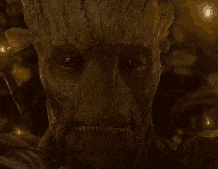 a close up of a man 's face with a picture of a tree in the background