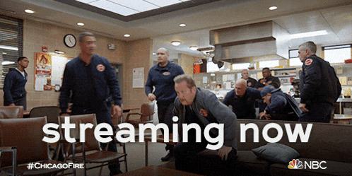 a group of firefighters are gathered around a couch with the words streaming now written on it