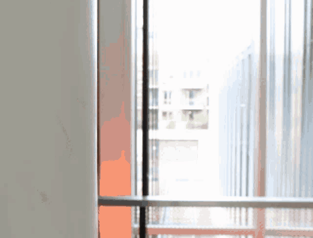 a blurred image of a window with a balcony behind it