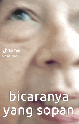 a close up of a woman 's face with the words " bicaranya yang sopan " written below it