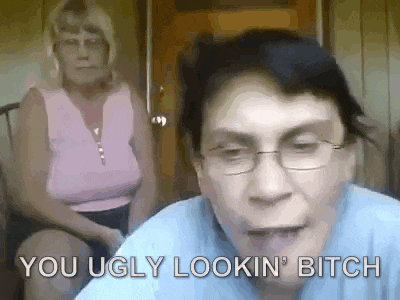 a woman with glasses is making a funny face while another woman sits behind her .
