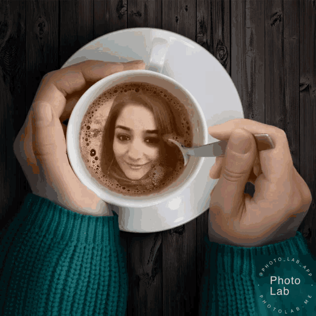 a person is holding a cup of coffee with a picture of a woman in the cup