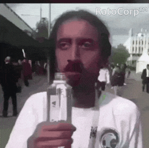 a man with a beard is holding a bottle of water