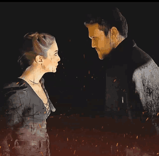 a man and a woman are looking at each other