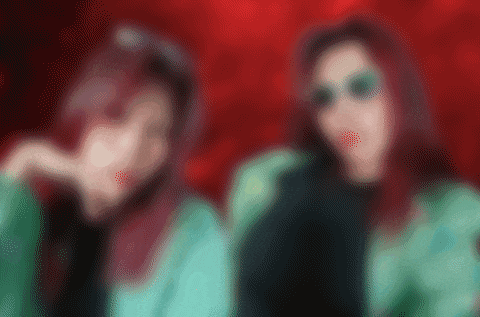a blurry picture of two women wearing sunglasses