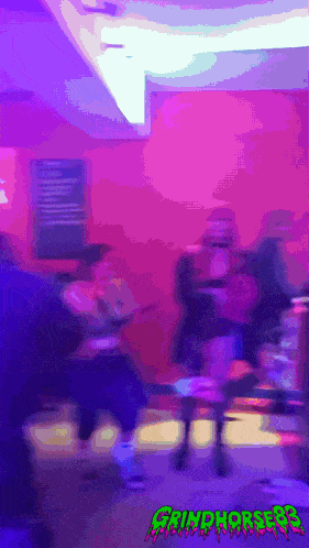 a blurry picture of people in a room with the word grimpres on the bottom right