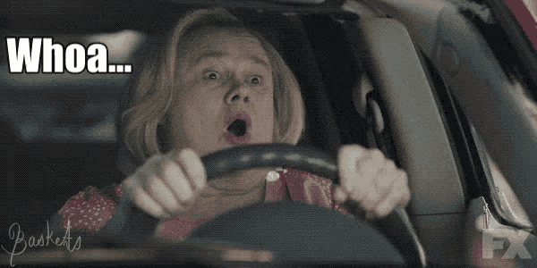 a woman driving a car with the words whoa written on the screen