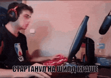 a man wearing headphones is playing a game on a computer