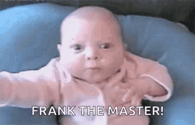 a baby is laying on a blue pillow and making a funny face while saying `` frank the master '' .