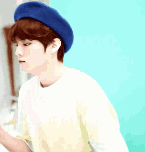 a boy wearing a blue hat and a white shirt