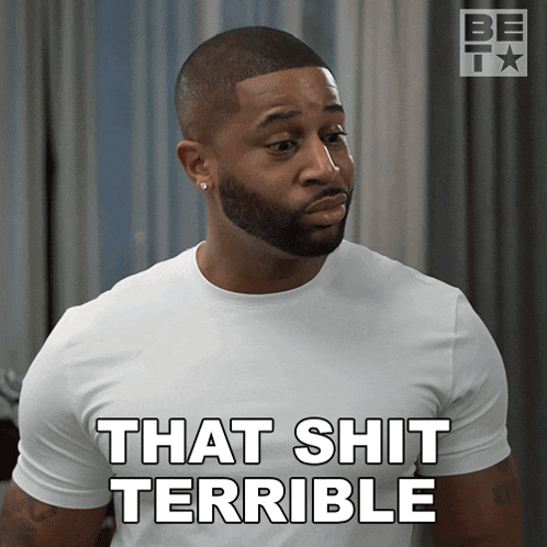 a man with a beard is wearing a white shirt that says that shit terrible