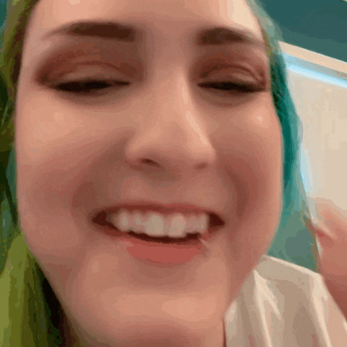 a close up of a woman 's face with a toothpick in her mouth
