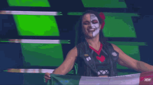 a woman holding a flag with aew written on the bottom right