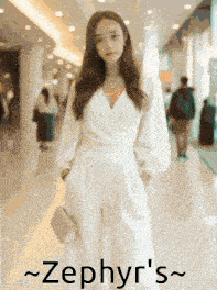 a woman in a white jumpsuit is standing in a hallway with the name zephyr 's written on the bottom