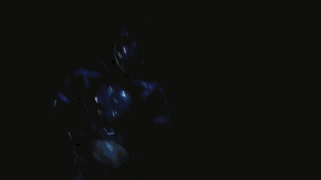 a person is standing in the middle of a purple circle in a dark room .