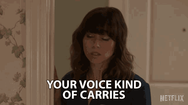 a woman says " your voice kind of carries " while standing in a doorway