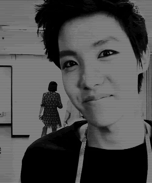 a black and white photo of a young man with short hair looking at the camera .
