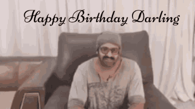 a man is sitting in a chair with the words happy birthday darling written on the bottom