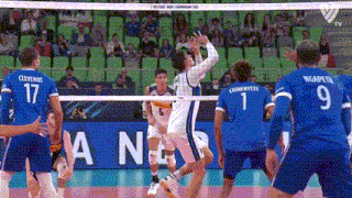 a volleyball game is being played in front of a banner that says ana on it