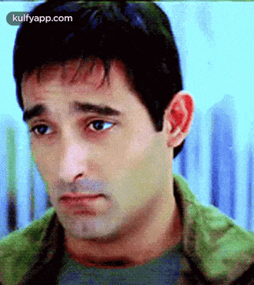 a close up of a man 's face with a sad look on his face