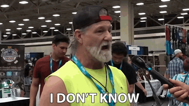 a man with a beard is talking into a microphone and says i don t know