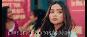 a woman is standing in front of a sign that says prostitute fan aagye bhagao .
