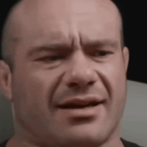 a close up of a man 's face with a sad expression .