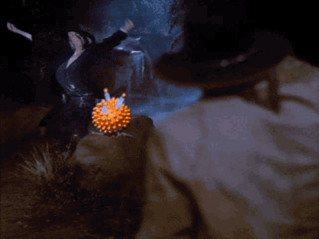 a person is holding a firework in front of a lightning strike