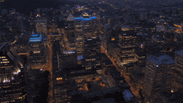 an aerial view of a city at night with cn on a building
