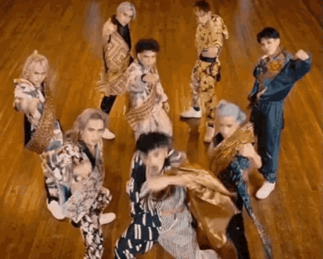 a group of people are dancing together on a wooden floor