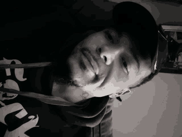 a man wearing a hat and a hoodie with the letter e on the front