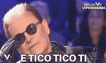 a man wearing sunglasses and a polka dot shirt says etico tico ti