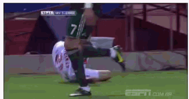 a soccer player with the number 7 on his jersey kicks the ball
