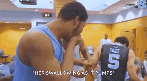 a group of basketball players standing in a locker room .