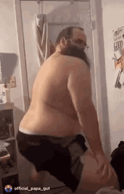 a shirtless man with a beard and glasses is dancing in a bathroom .