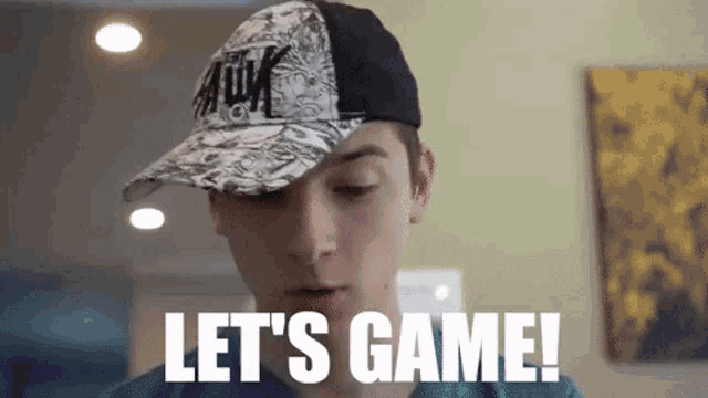 a boy wearing a baseball cap says let 's game