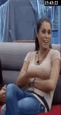 a woman is sitting on a couch with her legs crossed .