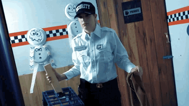 a security guard is standing in front of a private door
