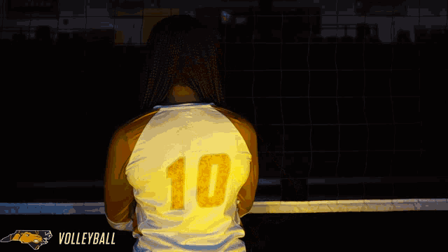 a woman wearing a volleyball jersey with the number 10