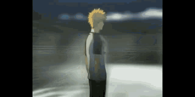 a man with blonde hair is standing in the water .