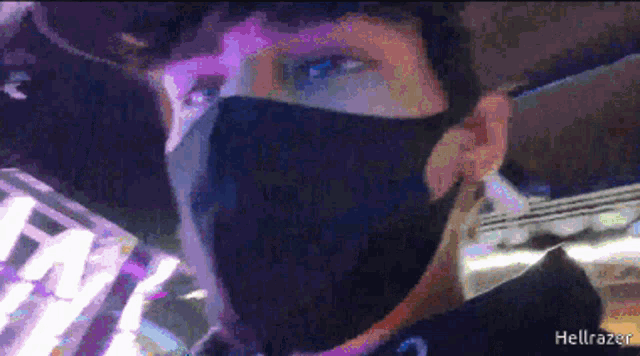 a pixelated image of a person wearing a face mask with the name hellrazer written on the bottom