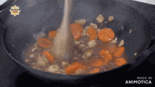 a wooden spoon is being used to stir vegetables in a pan that is made in animatica