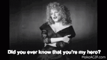 a black and white photo of a woman in a black dress with the words `` did you ever know that you 're my hero ''
