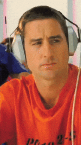 a man wearing headphones and an orange shirt with the number 25