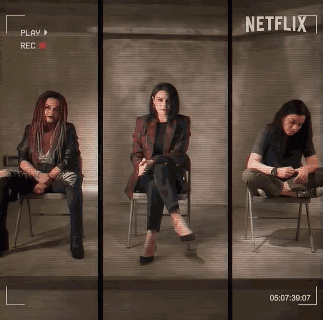 three women are sitting in chairs in front of a netflix screen