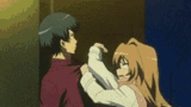 a man and a woman are standing next to each other .