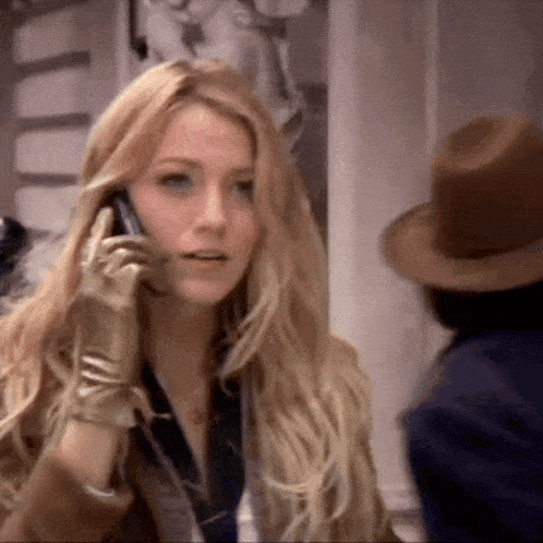 a woman wearing gloves is talking on her cell phone