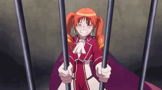a girl with red hair is behind bars with her mouth open .
