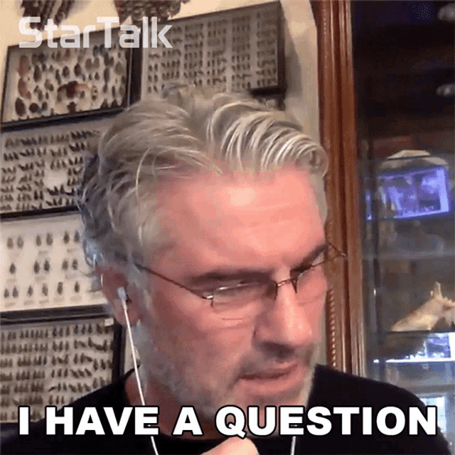 a man with glasses and earbuds says i have a question
